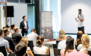Male business speaker giving a talk at business conference event